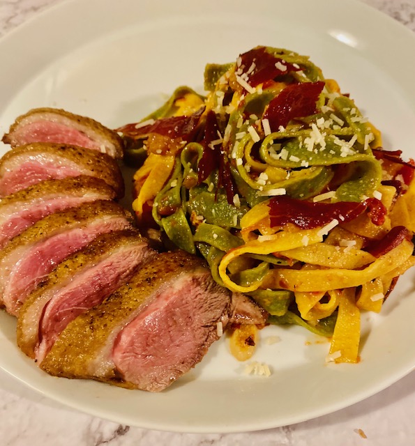 Tagliatelle with prosciutto, garlic tomato sauce and seared duck